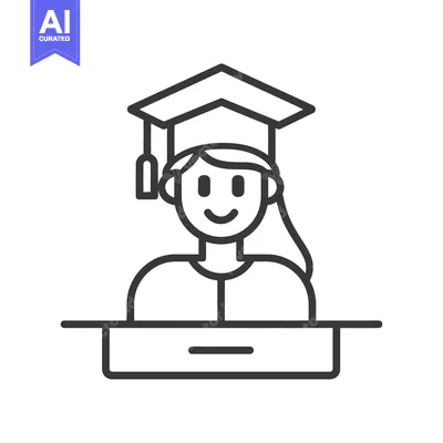 A graduating student stands behind a desk smiling at the viewer